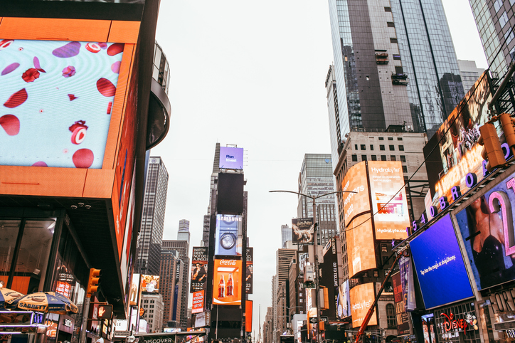 Looking up at the bright digital signage in Times Square. 